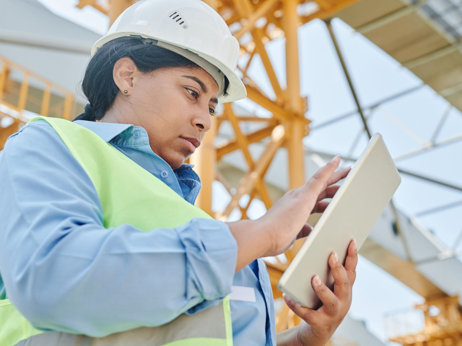 A construction manager using a tablet at a job site
