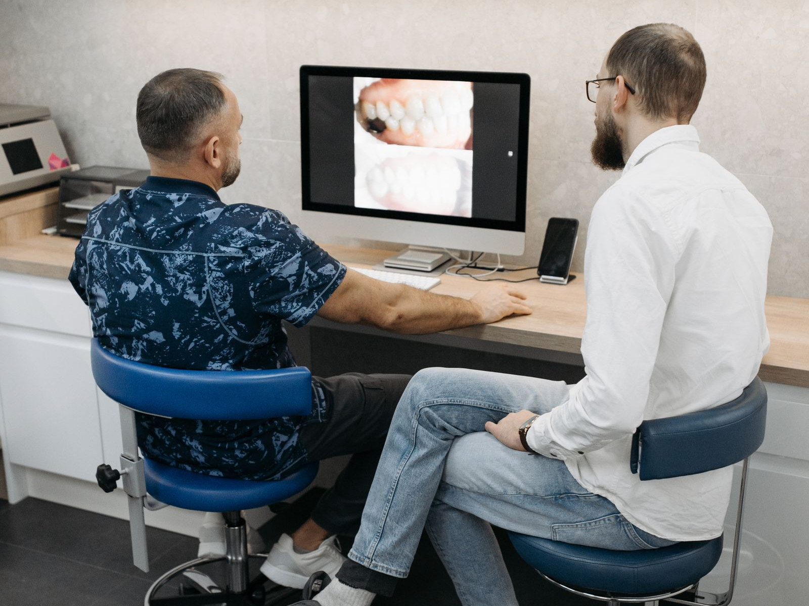Dental professionals reviewing digital patient imaging on a computer