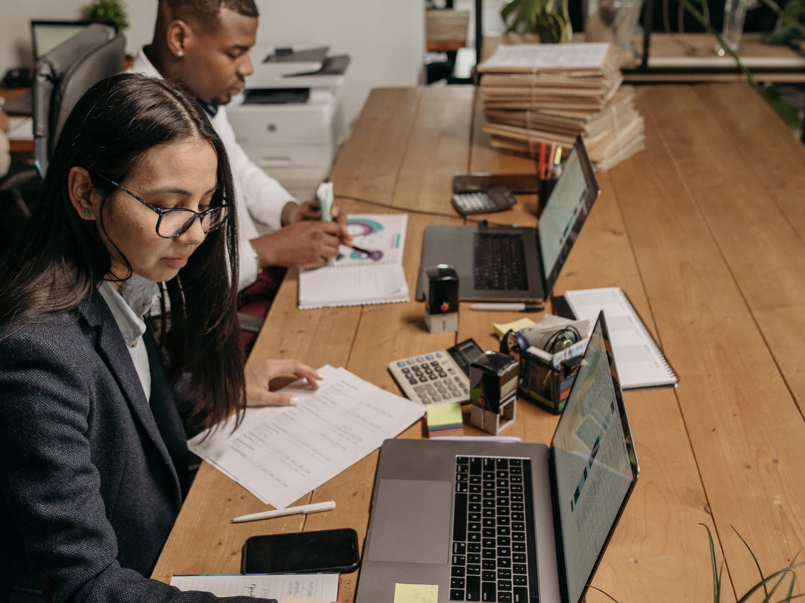 Accounting professionals working with financial documents and business software