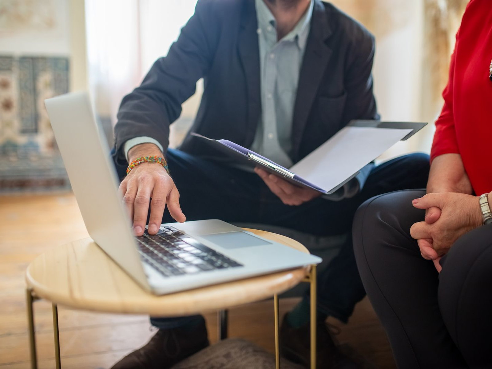 An attorney reviewing documents and a laptop with a client