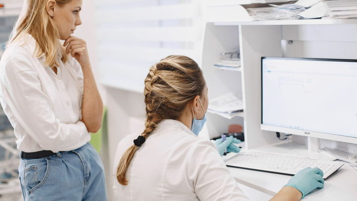 Medical practice staff using a computer during daily clinic operations