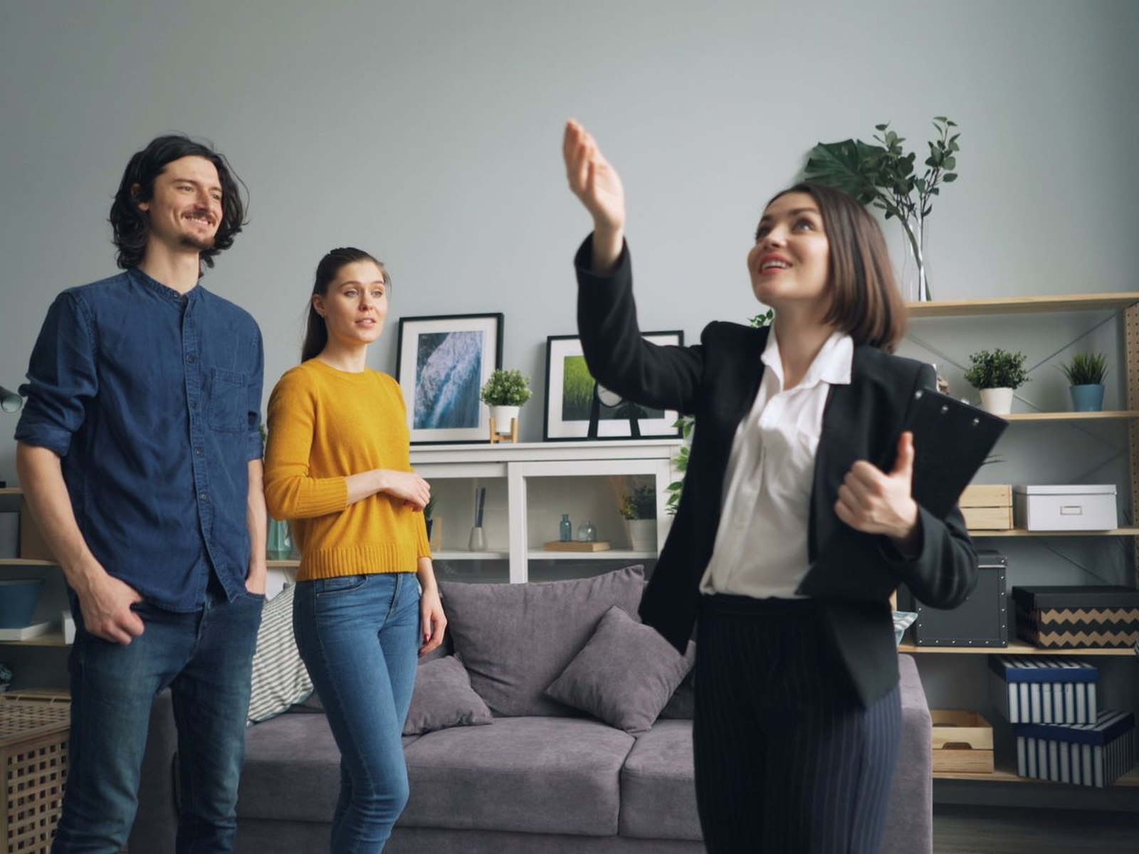 A real estate agent showing a modern home to prospective buyers