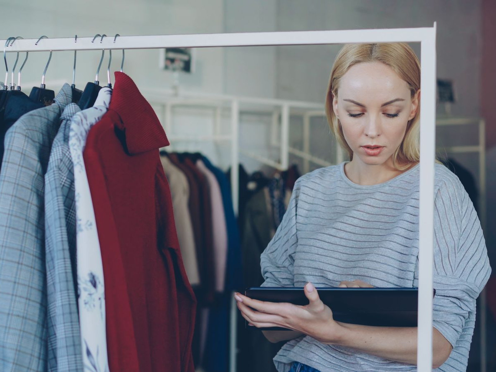 A retail employee using a tablet to manage store operations