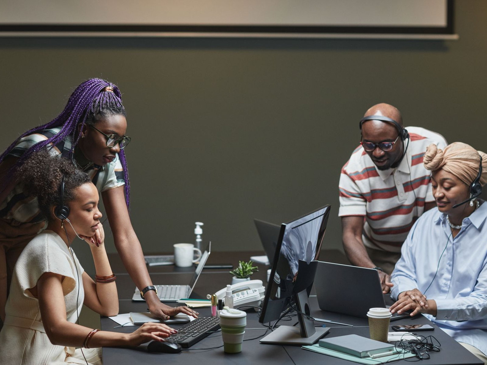 An IT support team helping employees from a modern service desk